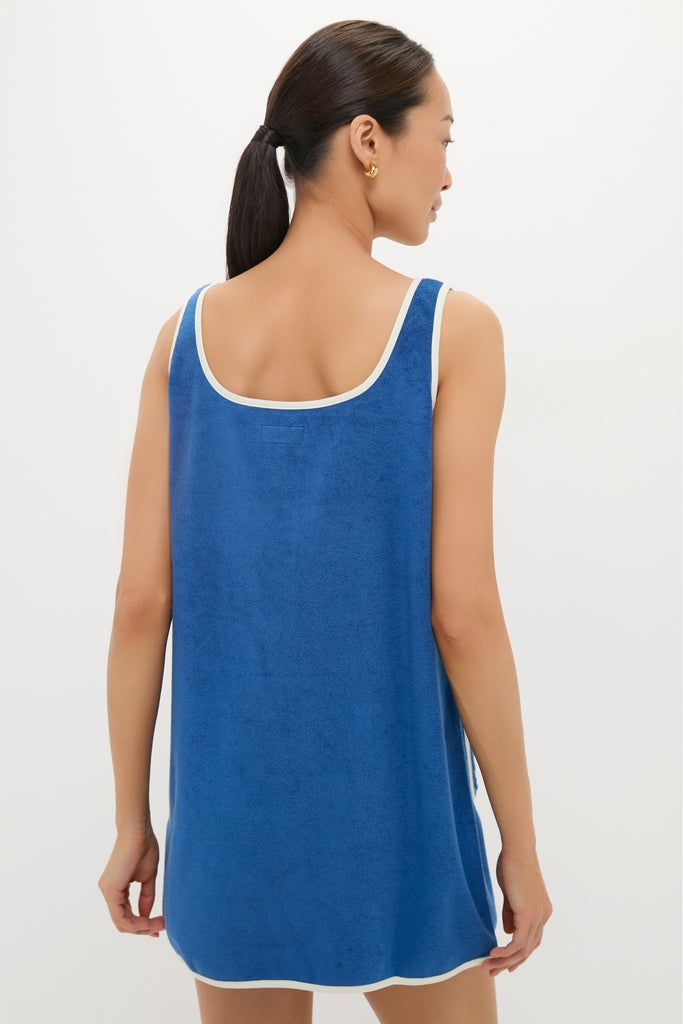 Woman in a classic, effortless Cobalt Embroidered Terrycloth Dress Coverup with white trim, embodying a high-end, fun style.