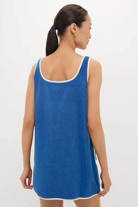 Woman in a classic, effortless Cobalt Embroidered Terrycloth Dress Coverup with white trim, embodying a high-end, fun style.
