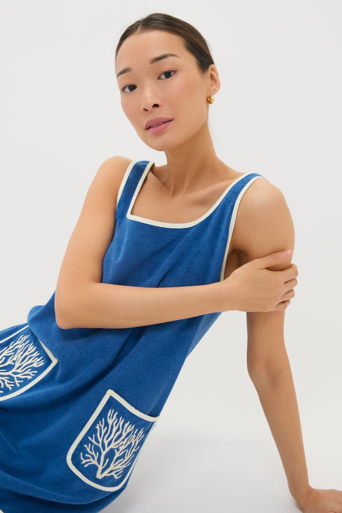 Cobalt Embroidered Terrycloth Dress Coverup: A classic, effortless knee-length royal-blue dress featuring off-white trim, fun front pockets with high-end embroidery, perfect for a cool, confident look.