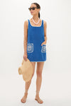 Model wearing the classic Cobalt Embroidered Terrycloth Dress Coverup, featuring an effortless sleeveless design, white-trimmed accents, fun sea-fan motif pockets, and a high-end, relaxed fit.