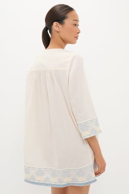 Woman wearing Neblina Geometric Embroidered Bondi Coverup, an effortless, classic off-white tunic with geometric patterns and fringe trim, embodying Tuckernuck's high-end, fun style.