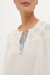 Neblina Geometric Embroidered Bondi Coverup showcases classic, effortless style with pale blue and soft yellow embroidery and light-blue tassels, embodying Tuckernuck's high-end, fun aesthetic.