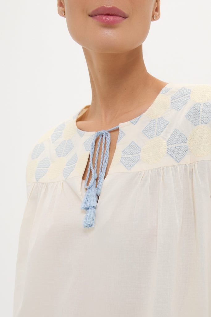 Neblina Geometric Embroidered Bondi Coverup showcases classic, effortless style with pale blue and soft yellow embroidery and light-blue tassels, embodying Tuckernuck's high-end, fun aesthetic.