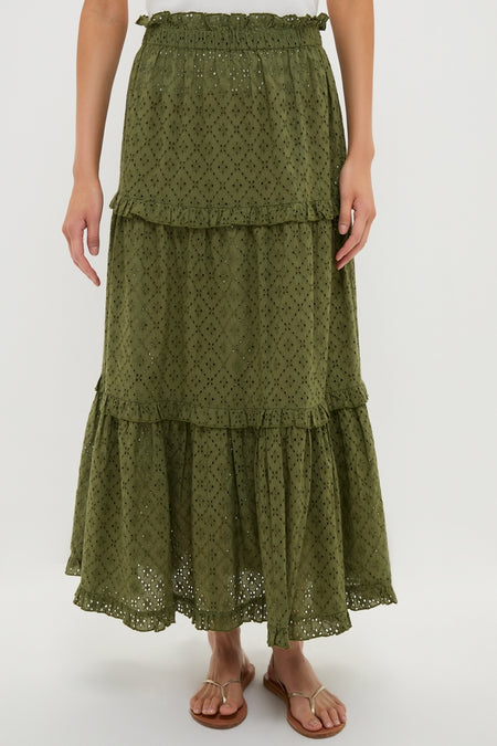 The Fern Eyelet Prado Skirt, a classic and effortless olive-green tiered design, features a ruffled waistband and scalloped hem, perfect for a fun, high-end look.
