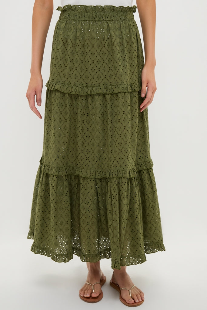 The Fern Eyelet Prado Skirt, a classic and effortless olive-green tiered design, features a ruffled waistband and scalloped hem, perfect for a fun, high-end look.