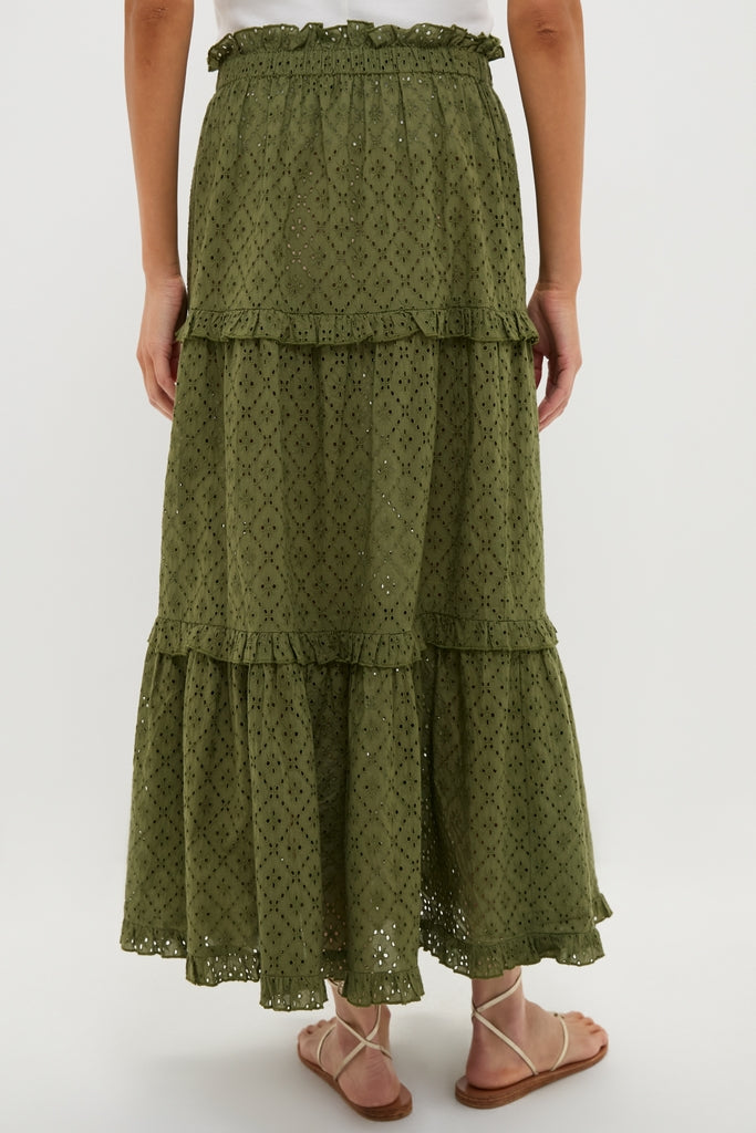 Back view of a woman wearing the classic Fern Eyelet Prado Skirt, an effortless tiered maxi with ruffle trims and elastic waistband, embodying fun and high-end style.