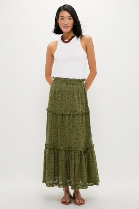 Woman in classic, effortless Fern Eyelet Prado Skirt featuring tiered layers and ruffled hem, styled with a high-neck tank top, sandals, and beaded necklace, exuding fun sophistication.