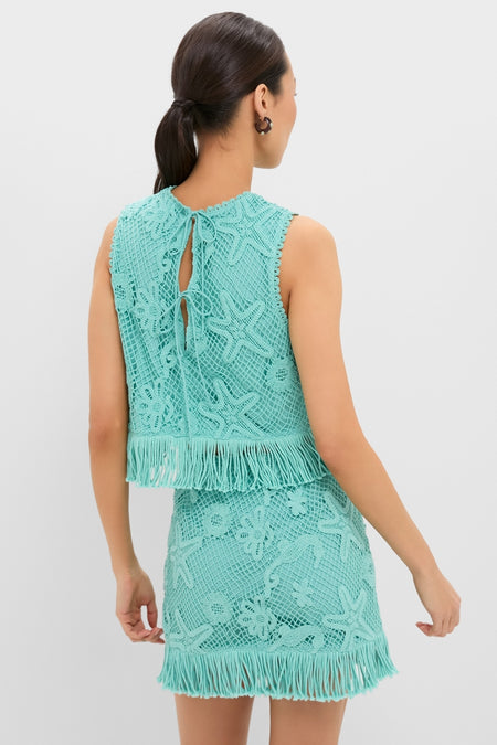 Woman in a classic, high-end Teal Samia Fringe Set featuring an effortless, fun crochet top and matching mini-skirt with sea-life motifs and fringe details.