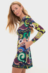 Woman wearing the Papalote Rubi Dress, a classic, long-sleeved A-line with an effortless, fun swirling floral and abstract print, exuding a high-end, confident style.