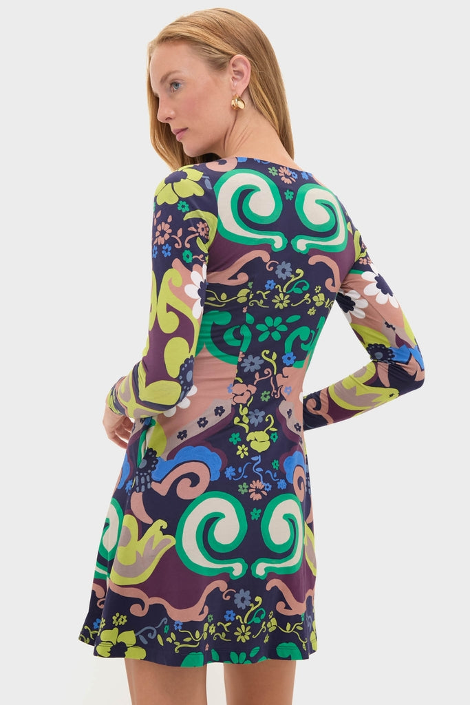 Woman in Papalote Rubi Dress, a classic, effortlessly chic, long-sleeve, above-the-knee dress with a bold abstract pattern, epitomizing fun and high-end style.