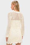 Model in an Ivory Knit Tamara Mini Dress, showcasing its classic open-knit design and scalloped hem, exuding effortless, high-end style with a fun, sophisticated touch.