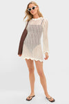 Model wearing the classic Ivory Knit Tamara Mini Dress, an effortless open-knit cover-up, paired with a black bikini, flip-flops, cat-eye sunglasses, and a woven shoulder bag.