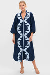 Navy & Baby Blue Embroidered Teresa Caftan exudes classic elegance with its symmetrical scroll pattern, voluminous sleeves, and effortless style, paired with tan sandals for a high-end, fun look.