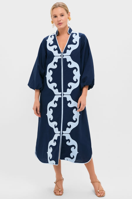 Navy & Baby Blue Embroidered Teresa Caftan exudes classic elegance with its symmetrical scroll pattern, voluminous sleeves, and effortless style, paired with tan sandals for a high-end, fun look.