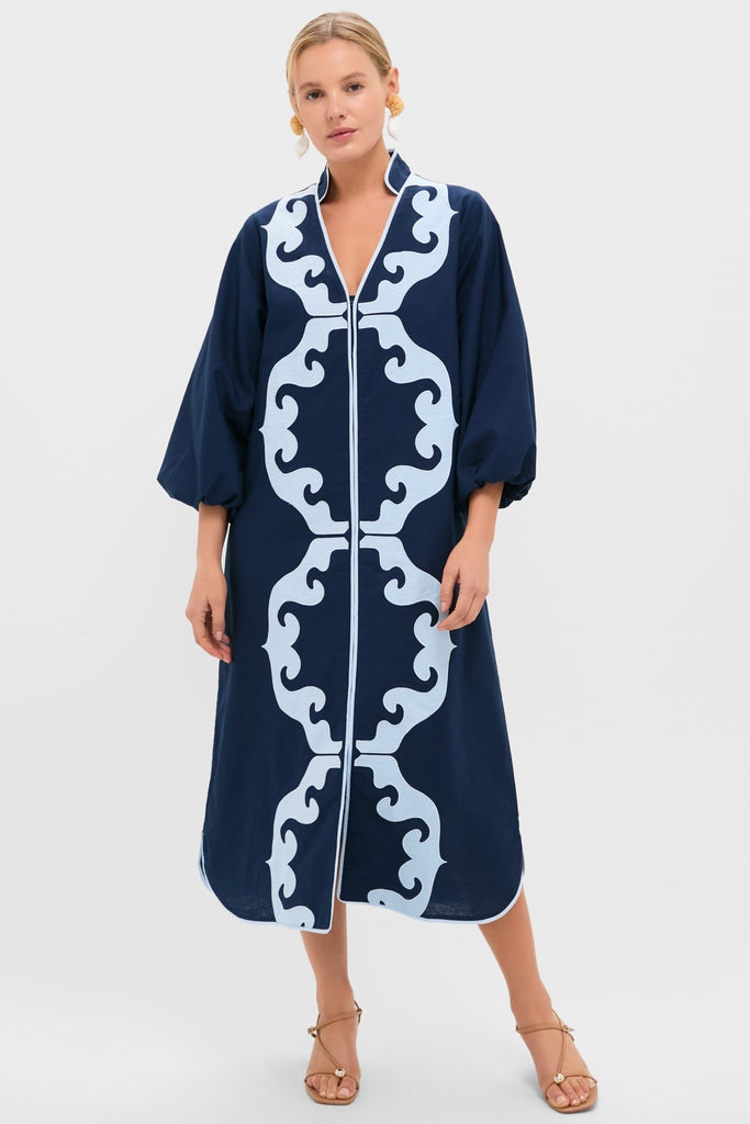 Navy & Baby Blue Embroidered Teresa Caftan exudes classic elegance with its symmetrical scroll pattern, voluminous sleeves, and effortless style, paired with tan sandals for a high-end, fun look.