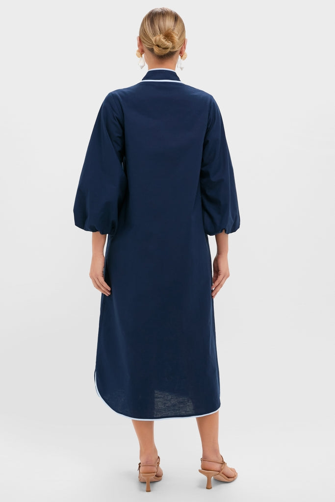 Woman in a classic Navy & Baby Blue Embroidered Teresa Caftan with balloon sleeves, effortless white trim, and fun sandals, exuding high-end style and confidence.