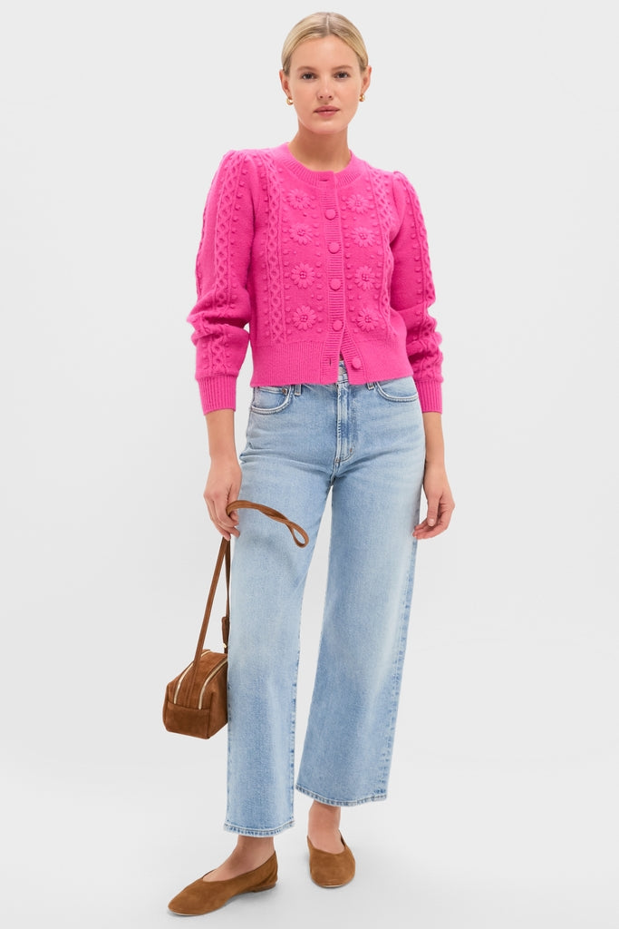 Woman wearing the classic Hot Pink Embroidered Floral Frankie Cardigan with straight-leg jeans, holding a suede handbag. An effortless, fun, and high-end look from Tuckernuck.