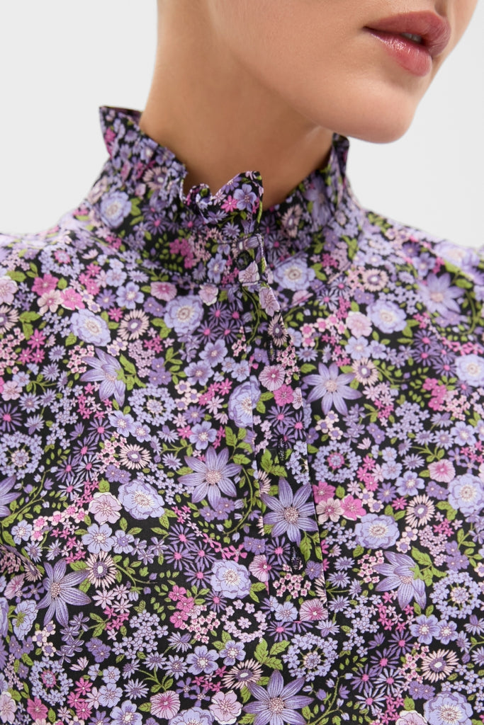 Close-up of the Shades of Purple Floral Florence Blouse, featuring a classic high-collared design with a ruffled tie, showcasing an effortless and fun floral pattern.