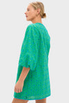 Model in side-profile wearing the Seafoam Palm Eyelet Mini Arem Caftan, a classic, high-end dress with floral eyelet pattern and puff sleeves, embodying effortless, fun style.