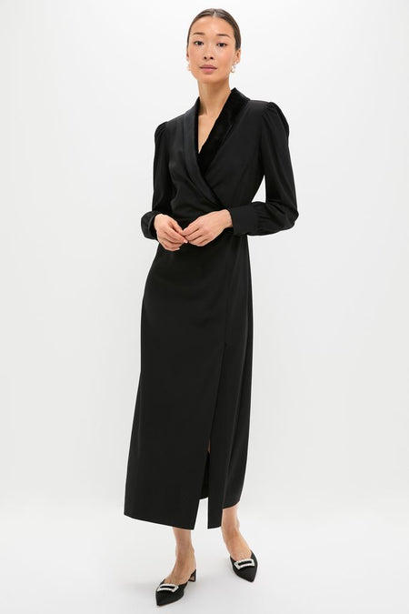 Woman in a classic Black Long Sleeve Mariella Midi Dress with puffed shoulders and side slit, pairing effortless elegance with fun, high-end style, featuring velvet trim and blouson sleeves.