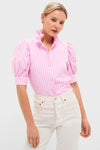 Woman wearing the Pink Candy Stripe Louisa Blouse with puffed sleeves and a ruffled collar, paired with high-waisted cream jeans, showcasing a classic and effortless high-end style.