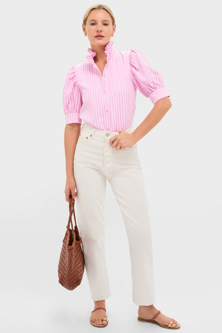 Model wearing the Pink Candy Stripe Louisa Blouse, featuring a ruffled stand-up collar and puff sleeves, paired with ivory jeans and a woven tote, exuding classic, effortless style.
