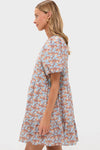 Woman in profile wearing a classic, effortless Brown & Powder Blue Floral Zip Front Ellie Mini Dress with puff sleeves, embodying fun and high-end style.