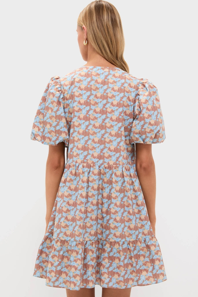 Model in elegant Brown & Powder Blue Floral Zip Front Ellie Mini Dress, featuring a tiered skirt, puff sleeves, and classic floral pattern for an effortless, high-end look.