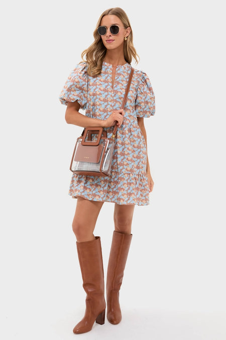 Model showcases the Brown & Powder Blue Floral Zip Front Ellie Mini Dress, exuding classic, effortless style with fun puff sleeves. Paired with high-end accessories for a chic look.