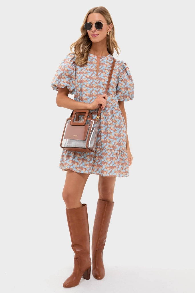 Model showcases the Brown & Powder Blue Floral Zip Front Ellie Mini Dress, exuding classic, effortless style with fun puff sleeves. Paired with high-end accessories for a chic look.
