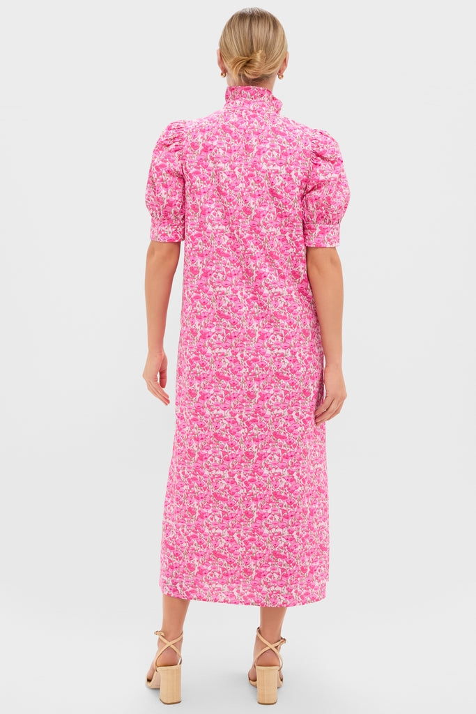 Woman modeling the classic Pink Poppies Floral Louisa Maxi Dress with a high, ruffled collar and puff sleeves, styled with effortless, fun, high-end appeal.