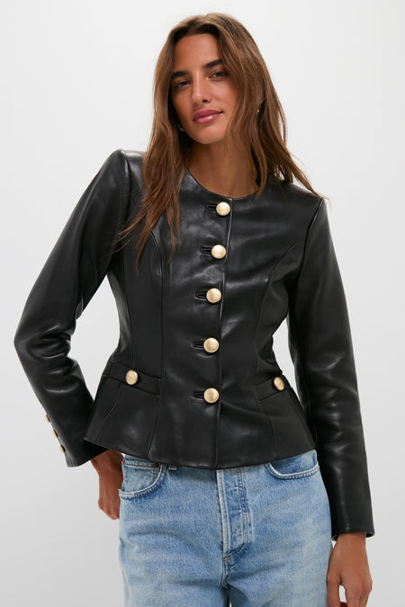 A person models the classic Black Mariella Collarless Blazer, featuring prominent gold buttons, exuding an effortless, high-end style paired with light-wash jeans, embodying fun sophistication.