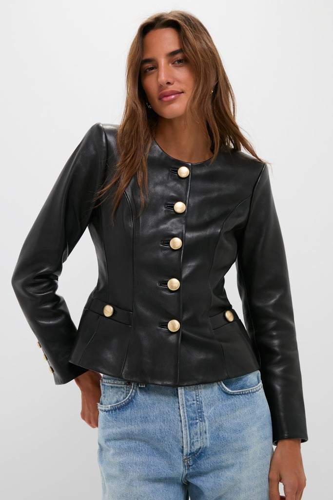 A person models the classic Black Mariella Collarless Blazer, featuring prominent gold buttons, exuding an effortless, high-end style paired with light-wash jeans, embodying fun sophistication.