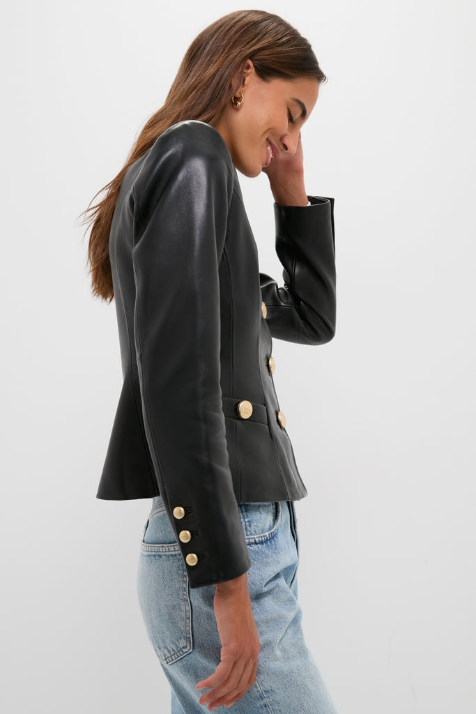 Model in profile wearing the Black Mariella Collarless Blazer with gold-tone buttons, paired with light-wash jeans, exuding a classic, effortless, and high-end style.