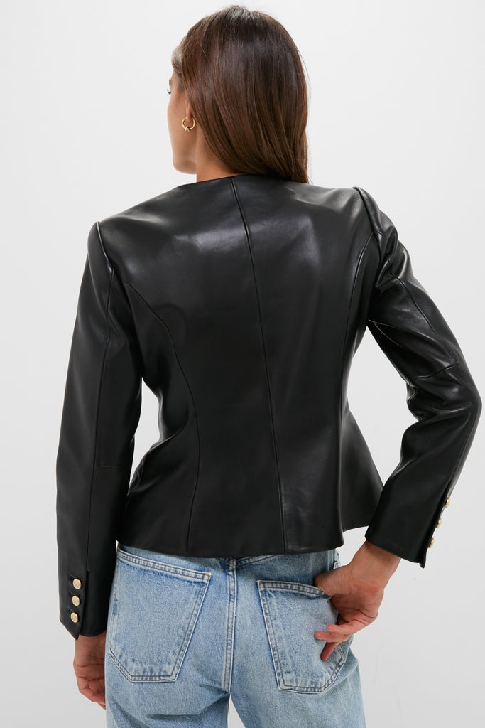 Black Mariella Collarless Blazer in smooth, fitted leather with gold-tone button cuffs, paired with light-wash jeans for a classic, effortless, and high-end look.