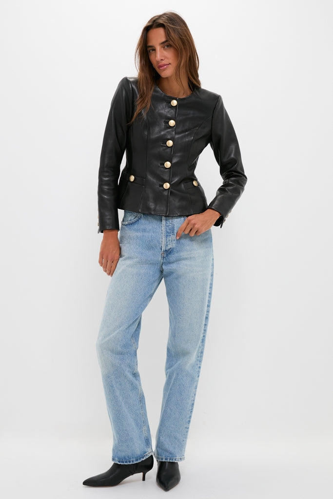 Woman wearing Black Mariella Collarless Blazer, a classic and high-end leather jacket with gold-tone buttons, paired with jeans and kitten-heel boots for an effortlessly cool look.
