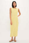 Young woman in Lemongrass Kingston Knit Dress, a classic, effortless sheath maxi, styled with tan sandals for a high-end, fun look.