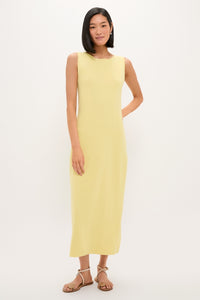 Young woman in Lemongrass Kingston Knit Dress, a classic, effortless sheath maxi, styled with tan sandals for a high-end, fun look.