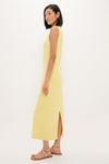 Lemongrass Kingston Knit Dress: Classic, effortless column-style midi with a chic slit, modeled by a slim woman in strappy sandals, embodying high-end, fun sophistication.