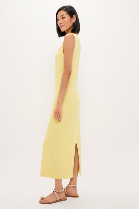 Lemongrass Kingston Knit Dress: Classic, effortless column-style midi with a chic slit, modeled by a slim woman in strappy sandals, embodying high-end, fun sophistication.