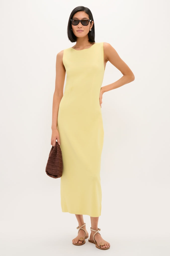 Lemongrass Kingston Knit Dress: A classic, effortless column-style midi dress paired with beige strappy sandals and a woven handbag, embodying fun and high-end fashion.