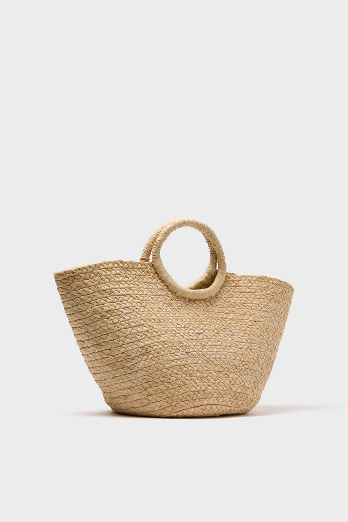 Natural Mimi Basket: A classic, high-end raffia tote with a trapezoidal shape, circular handles, and gold charm. Effortless style for fun beach or market outings.