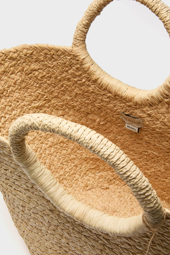 Natural Mimi Basket, a classic hand-woven raffia tote with circular ring handles and gold-beaded charms, offers an effortless, high-end accessory for fun, stylish getaways.