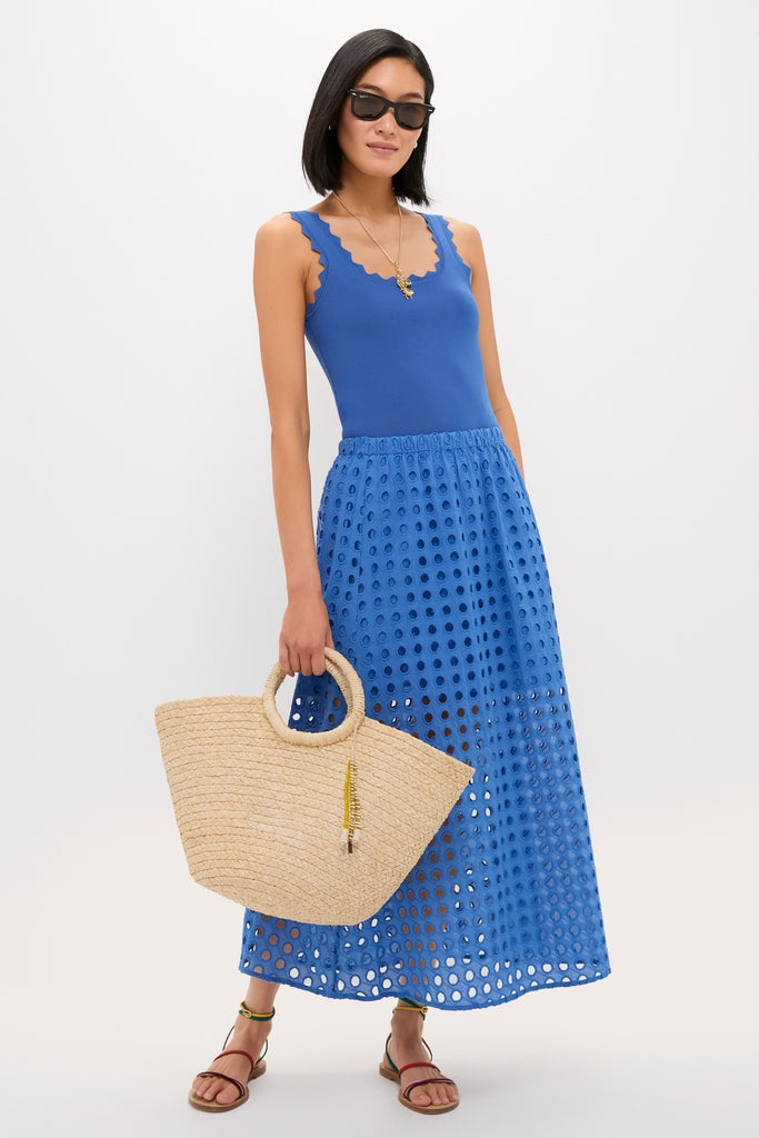 Model in a classic, effortless summer outfit with a cobalt-blue ensemble, showcasing the high-end Natural Mimi Basket tote, perfect for a fun, chic getaway.