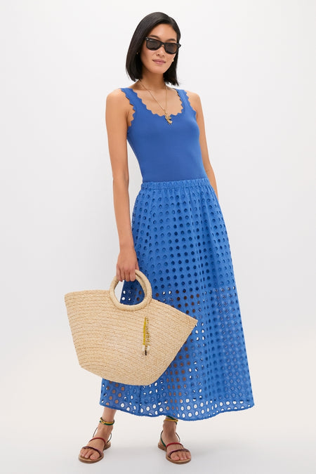 Model in a classic, effortless summer outfit with a cobalt-blue ensemble, showcasing the high-end Natural Mimi Basket tote, perfect for a fun, chic getaway.