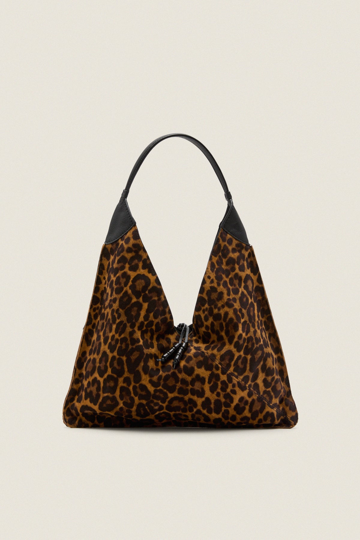 Leopard Medium Origami Shoulder Bag in slouchy leopard print with black leather trim and drawstring closure, embodies classic high-end style for effortless, fun day-to-night versatility.