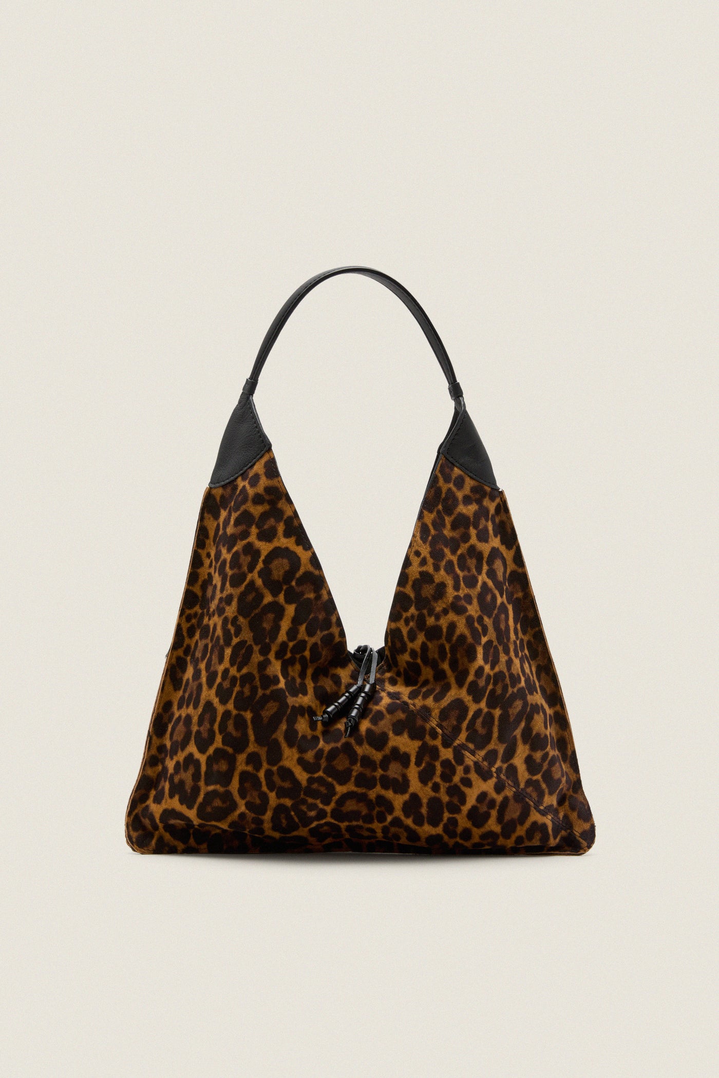 Leopard Medium Origami Shoulder Bag in slouchy leopard print with black leather trim and drawstring closure, embodies classic high-end style for effortless, fun day-to-night versatility.