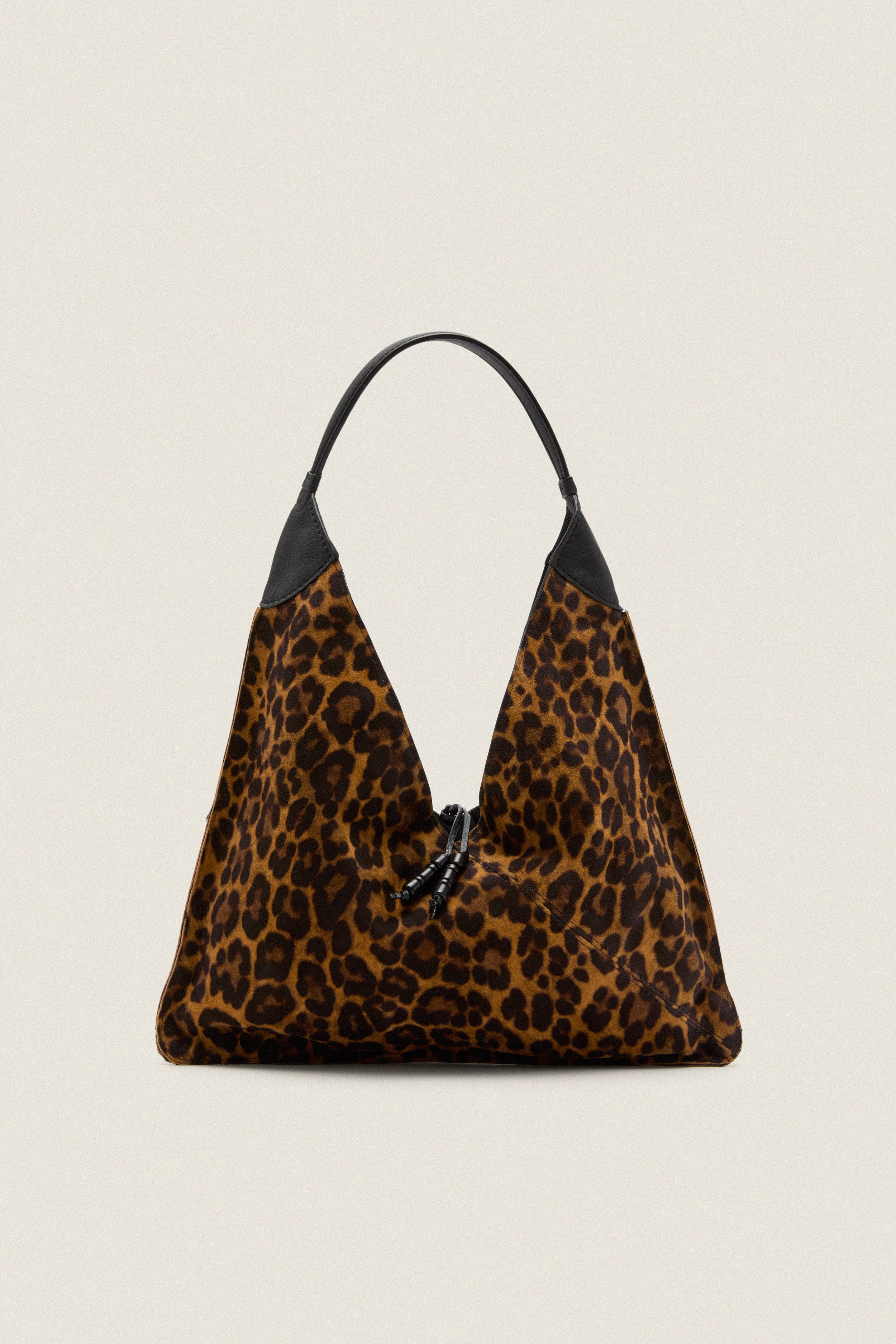 Leopard Medium Origami Shoulder Bag in slouchy leopard print with black leather trim and drawstring closure, embodies classic high-end style for effortless, fun day-to-night versatility.