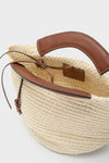 Natural Fique Small Shopper, a classic woven straw tote with crochet sides, brown leather trim, and handles, exudes an effortless high-end style, perfect for fun, versatile outings.