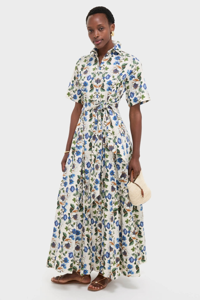 Woman modeling a classic shirt-dress with floral print and self-tie waist, holding a Natural Fique Small Shopper, embodying effortless style with fun, high-end accessories.